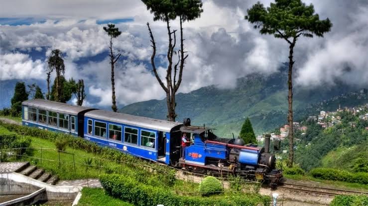 Darjeeling Himalayan Railway Toy Train travelling through the scenic Himalayan hills after Lonely Planet recognition